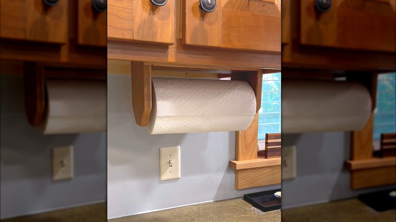 Paper towel roll on matching custom dispenser beneath classic style kitchen cabinets
