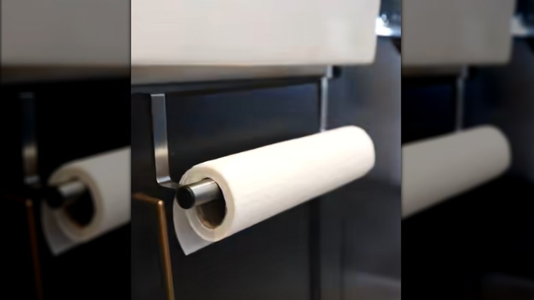 Metal towel rod installed beneath sink with paper towel roll