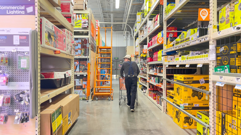 Man looking at products while shopping at Home Depot