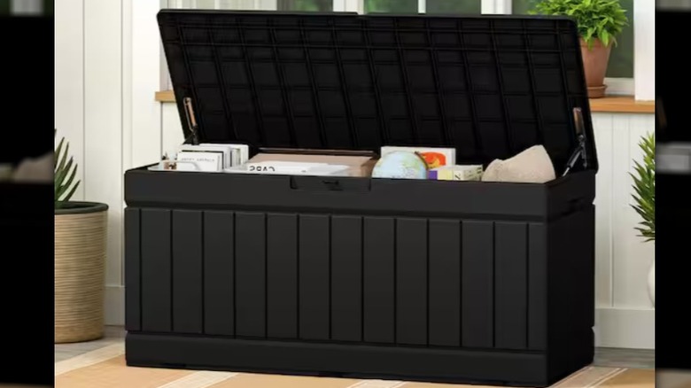A large black storage box filled with trinkets