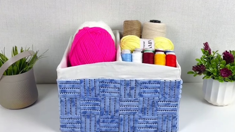 Sewing supplies organized in upcycled shoebox with fabric lining.