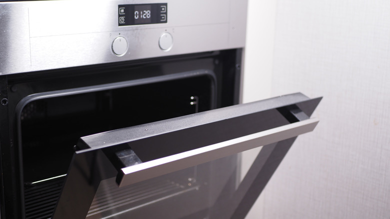 An electric oven with the door ajar