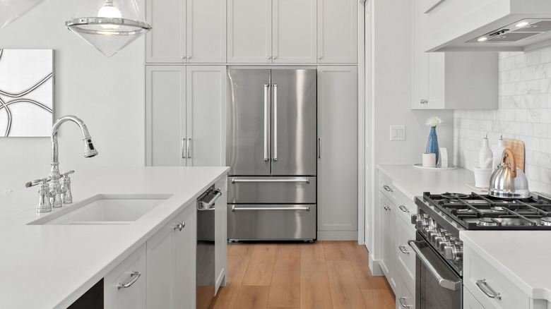 White kitchen with a silver refrigerator