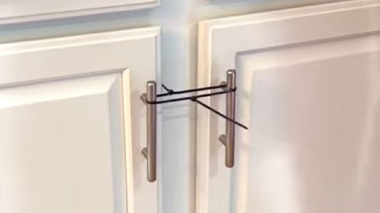 Cabinets with zip ties for babyproofing