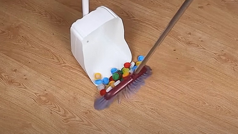 Using a dustpan made from a plastic jug