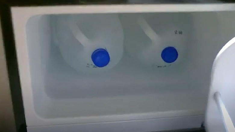 Water-filled milk jugs in freezer