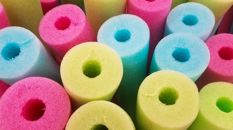 Colorful pool noodles are shown in a closeup shot