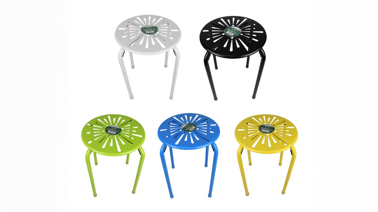 Several colorful metal plant stands on display