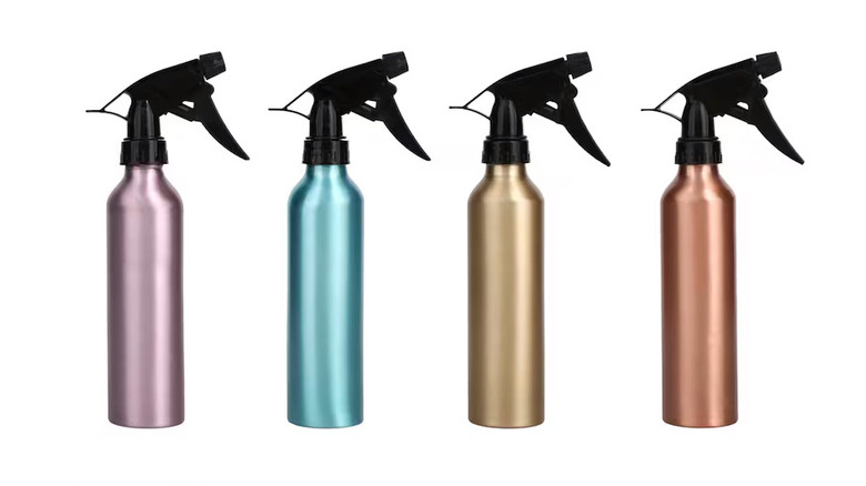 Four pastel aluminum spray bottles on display