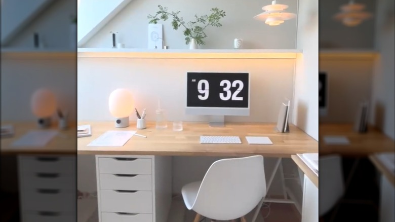 Lighting strips hung on picture ledge above computer desk