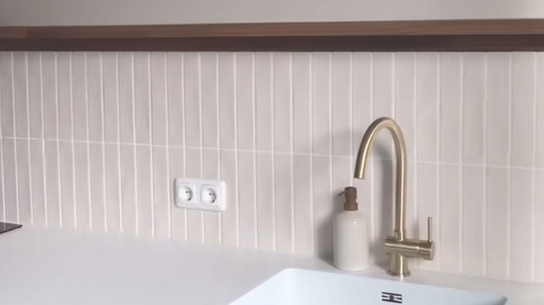 Oak IKEA picture ledge above backsplash in minimalist kitchen with natural accents