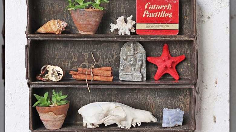 A vintage industrial style bread pan repurposed as a display on the wall.