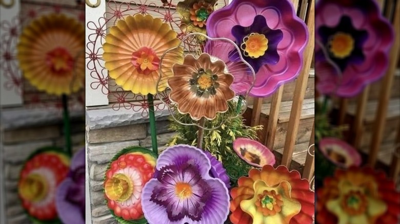 Flowers made out of painted, upcycled cake and baking pans