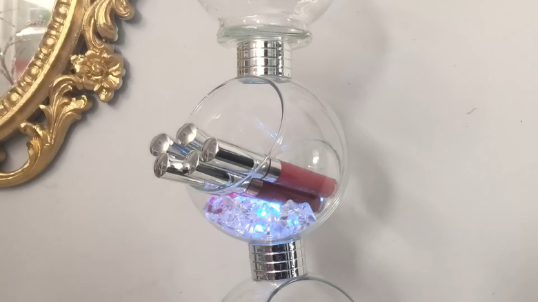 Tiered fishbowl organizer with gems and makeup