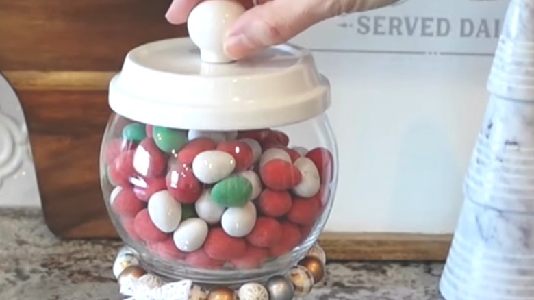 Holiday Dollar Tree candy dispenser made from vase, gardening supplies, and crafting accessories
