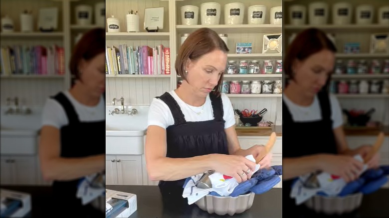 Young woman packing cake pan with kitchen supplies in classic farmhouse style kitchen