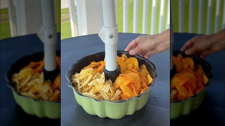 Wavy potato chips in repurposed cake pan with umbrella on outdoor patio table