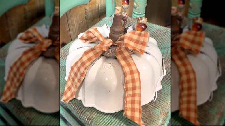 Autumn-themed Bundt pan pumpkin with plaid bowl and fall embellishments on antique setting