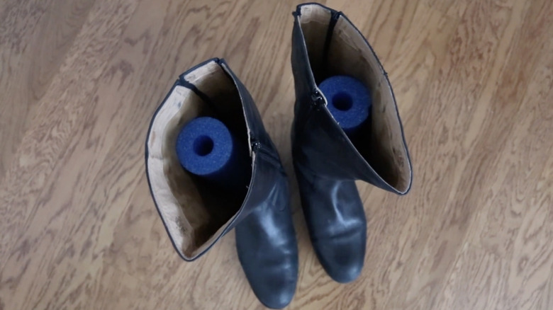 Black boots with noodles in them to hold upright