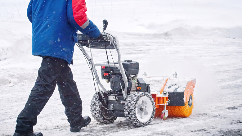 Person pushing snow blower