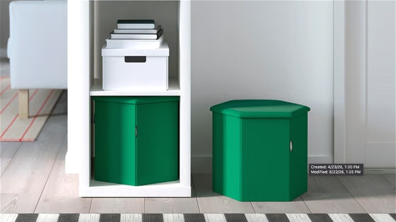 A green KJUGE pouf on an entryway floor and another in a narrow bookcase