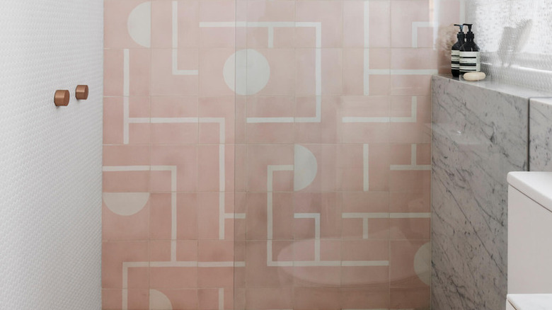 A bathroom with a pink shower