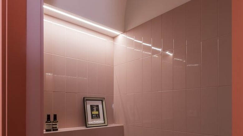 pink bathroom with dramatic lighting and floating vanity