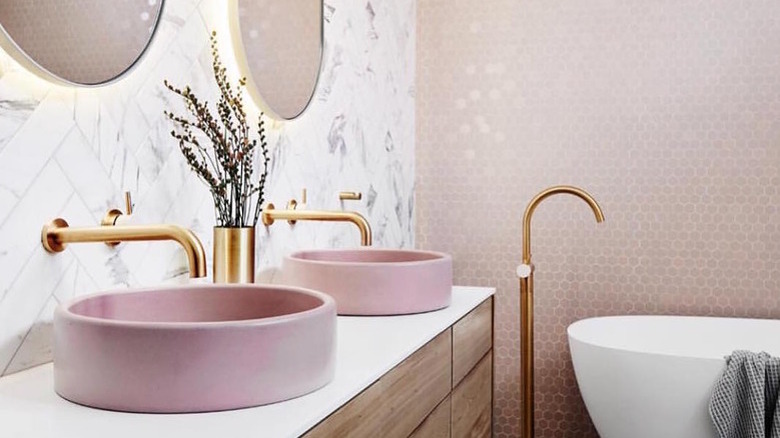 A bathroom with a pink tile wall