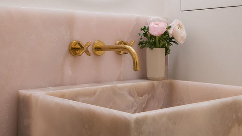 bathroom with pink onyx backsplash and sink