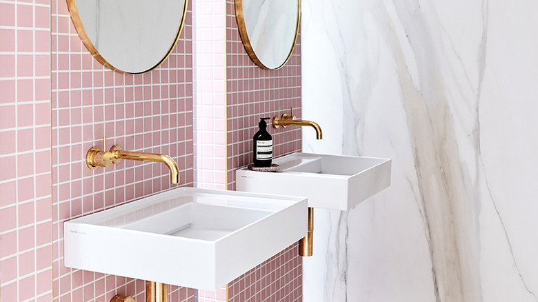 bathroom with pink tile and marble slab walls