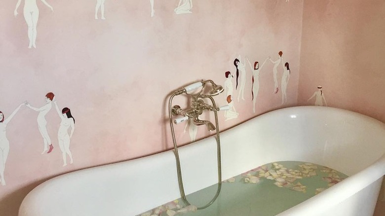 A bathroom with pink wallpaper