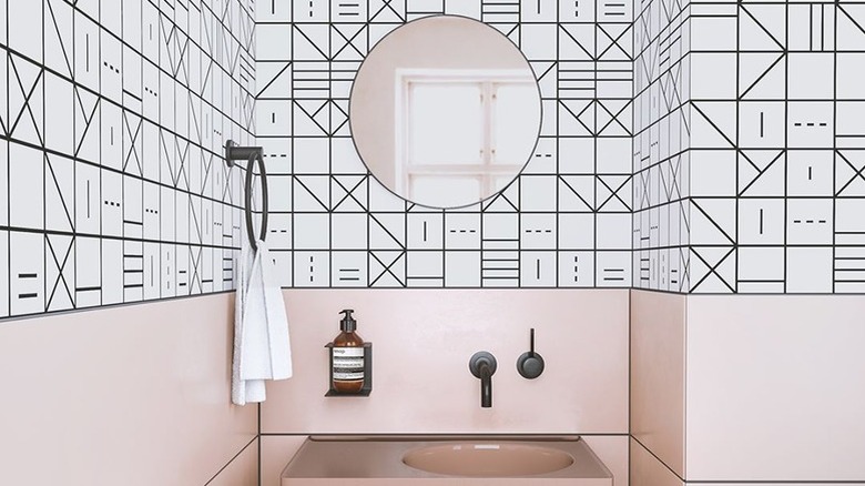 A bathroom with pink and black design details