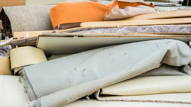 Carpet waste sits in a pile on the floor