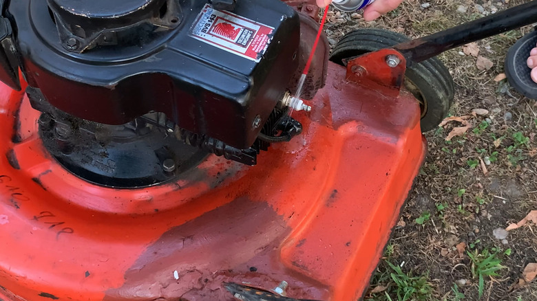 Cleaning a mower's spark plug and plug wire with WD-40