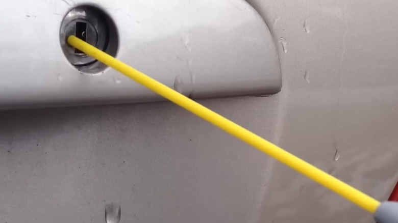 Spraying WD-40 into a seized lock cylinder