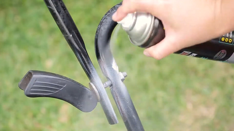 Lubricating a push mower's folding pivot point with WD-40