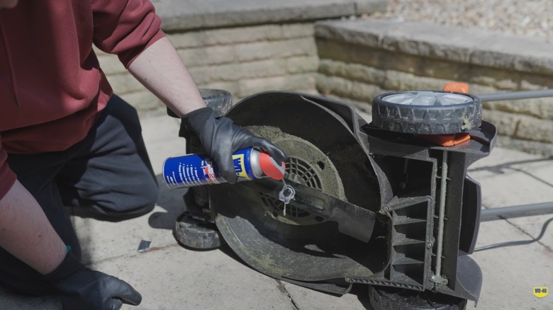 Using WD-40 lubricant on a mower deck