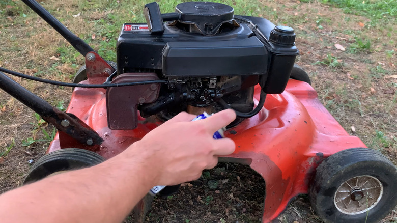 Rustproofing a mower engine's exterior with WD-40
