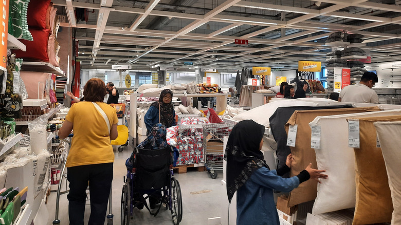 Several customers look at items on the shelves at IKEA