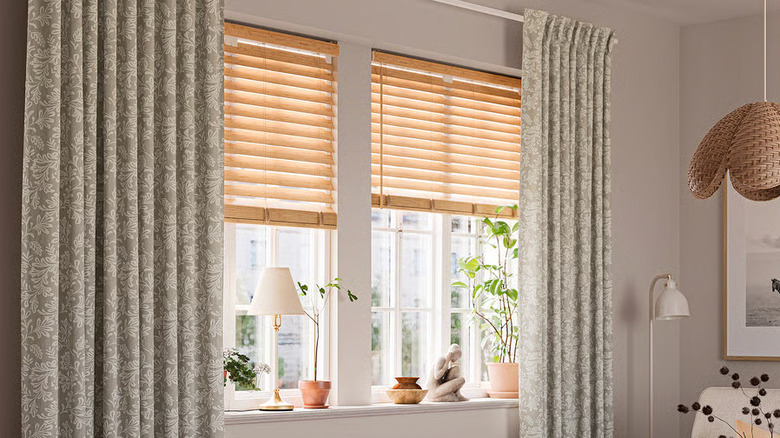 A large, light-filled window is flanked by two sage green and cream patterned SNÖRUTA Curtains