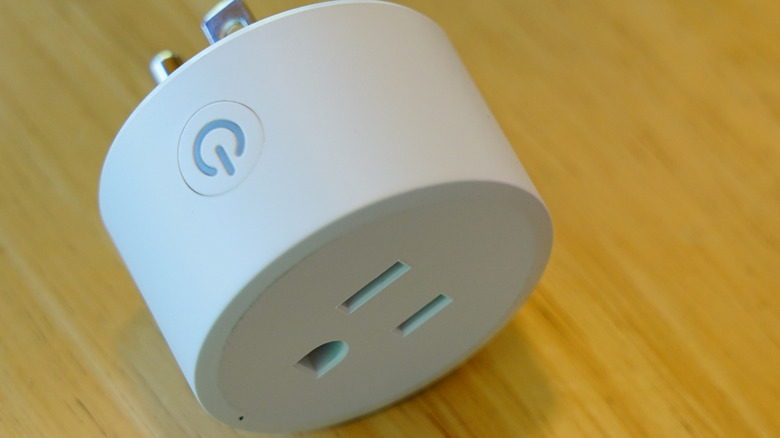 A typical smart plug with a manual power button