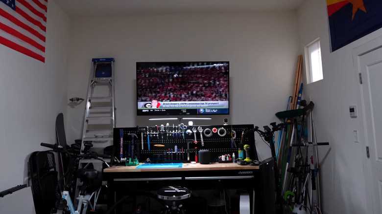 TV playing football game in a garage