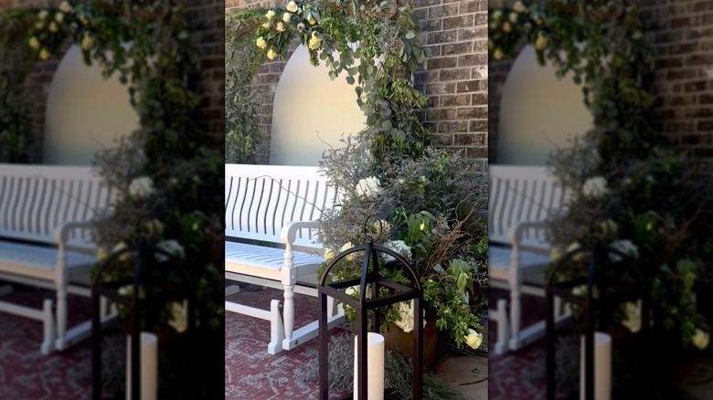 Beautiful plant and flower-covered archway for outdoor bench made of PVC pipes