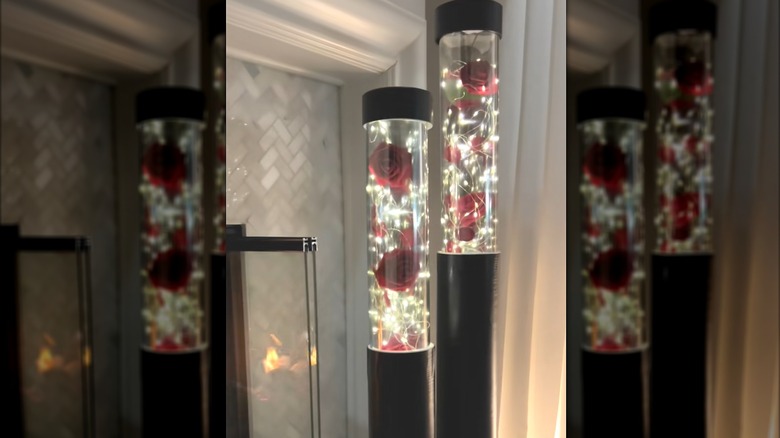 Artificial roses and string lights in Beauty and the Beast-inspired PVC pipe holder