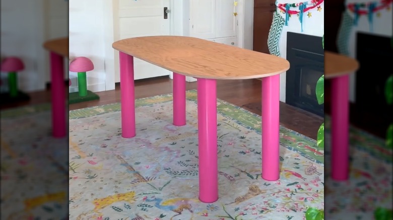 DIY retro table with wood oval surface and hot pink PVC pipe legs