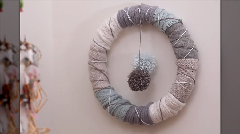 Various garments wrapped around wreath foam with pom poms