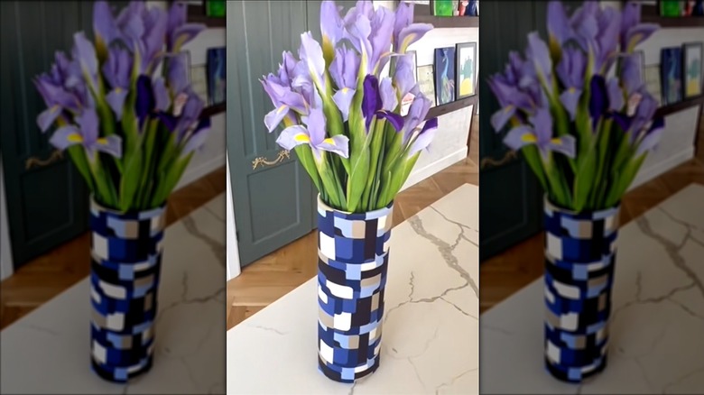 Geometric vase cover for purple flower bouquet made from folded retro blouse