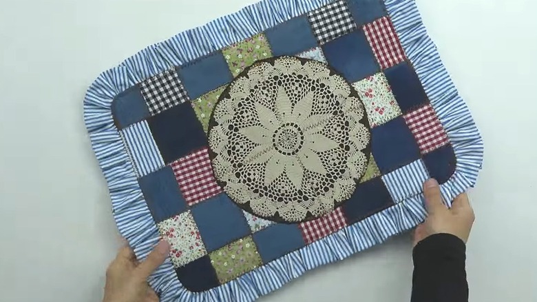 Quilt placemat made from fabric pieces and lace doily
