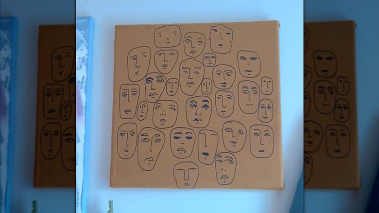 Brown Shein graphic t-shirt repurposed as eccentric canvas wall art