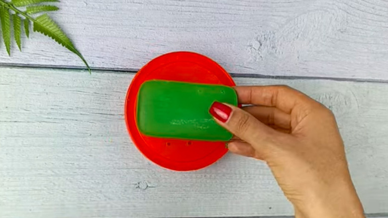 Soap dish made from reused red plastic lid